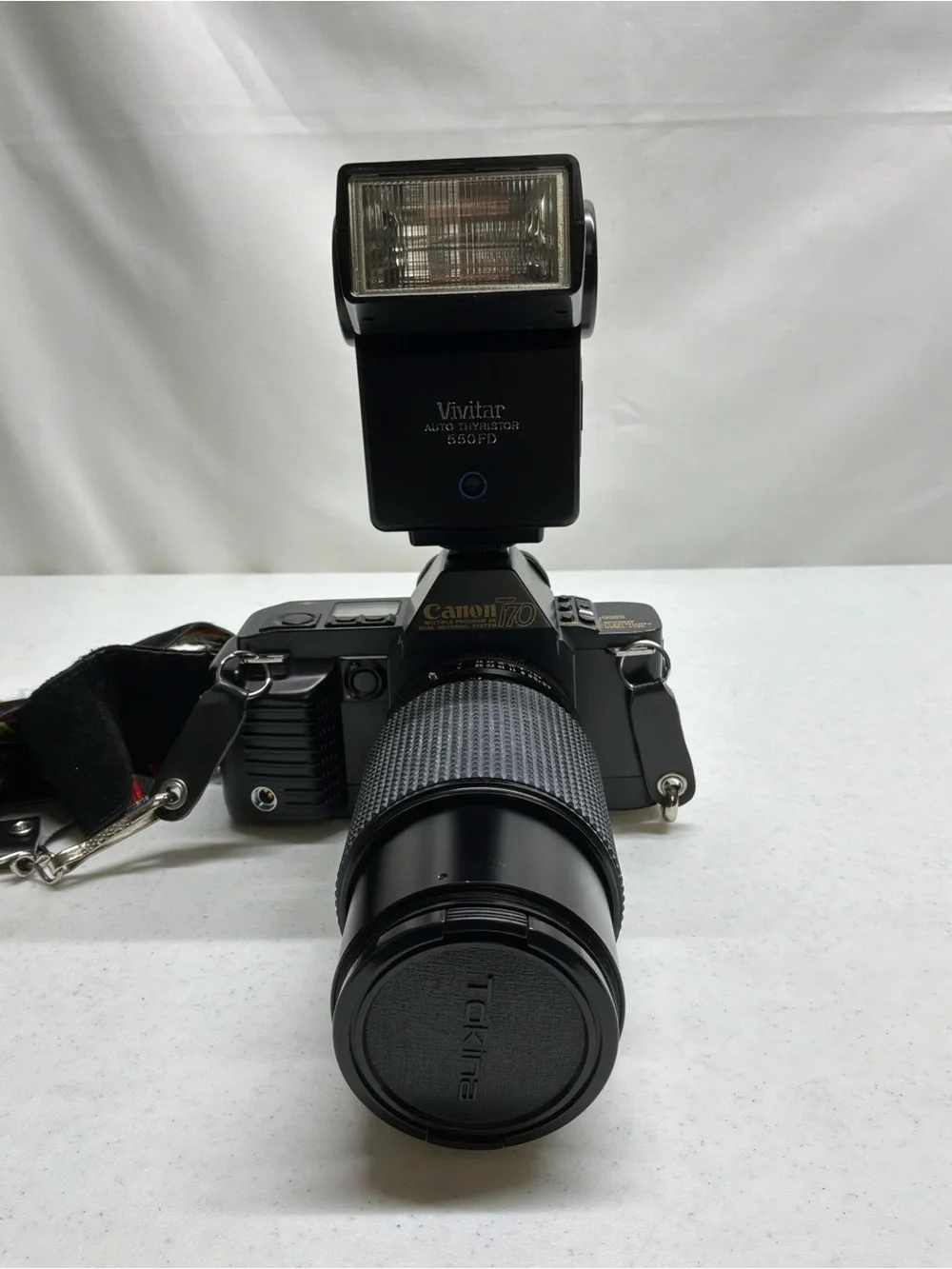 Canon T70 35mm SLR Camera with Black Telephoto Lens and Accessories